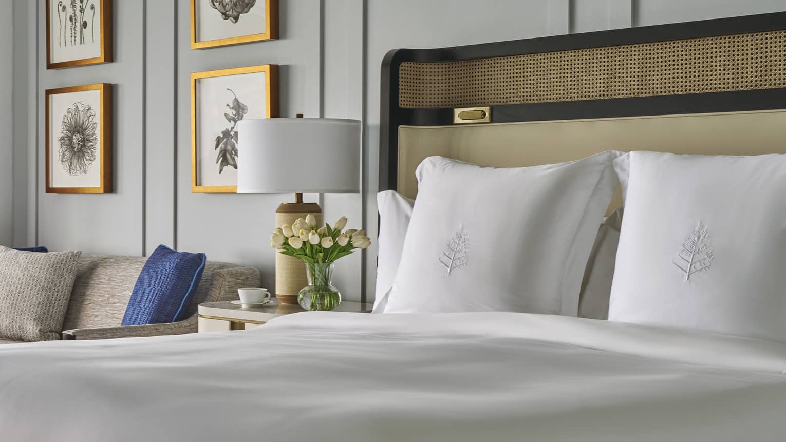 King bed with white sheets and Four Seasons-embroidered shams