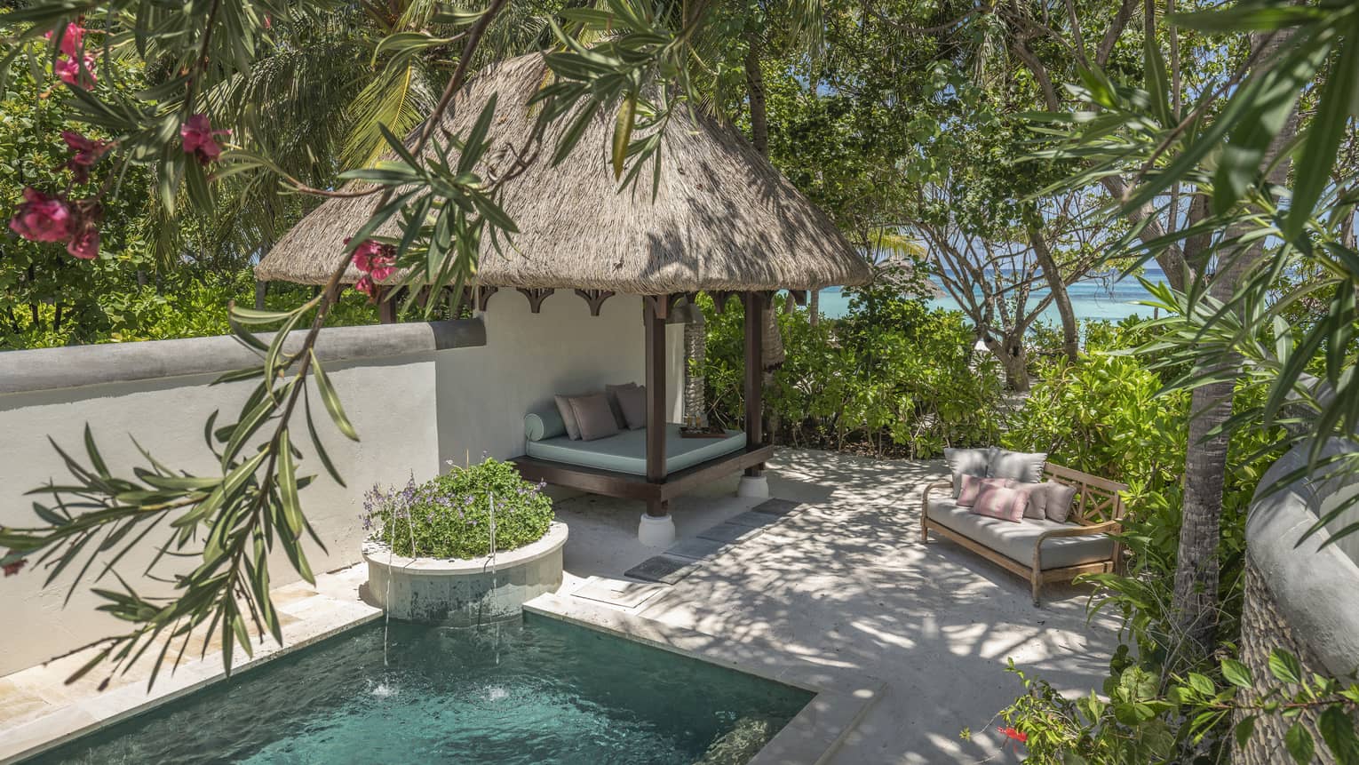 Private pool with thatched-roof cabana