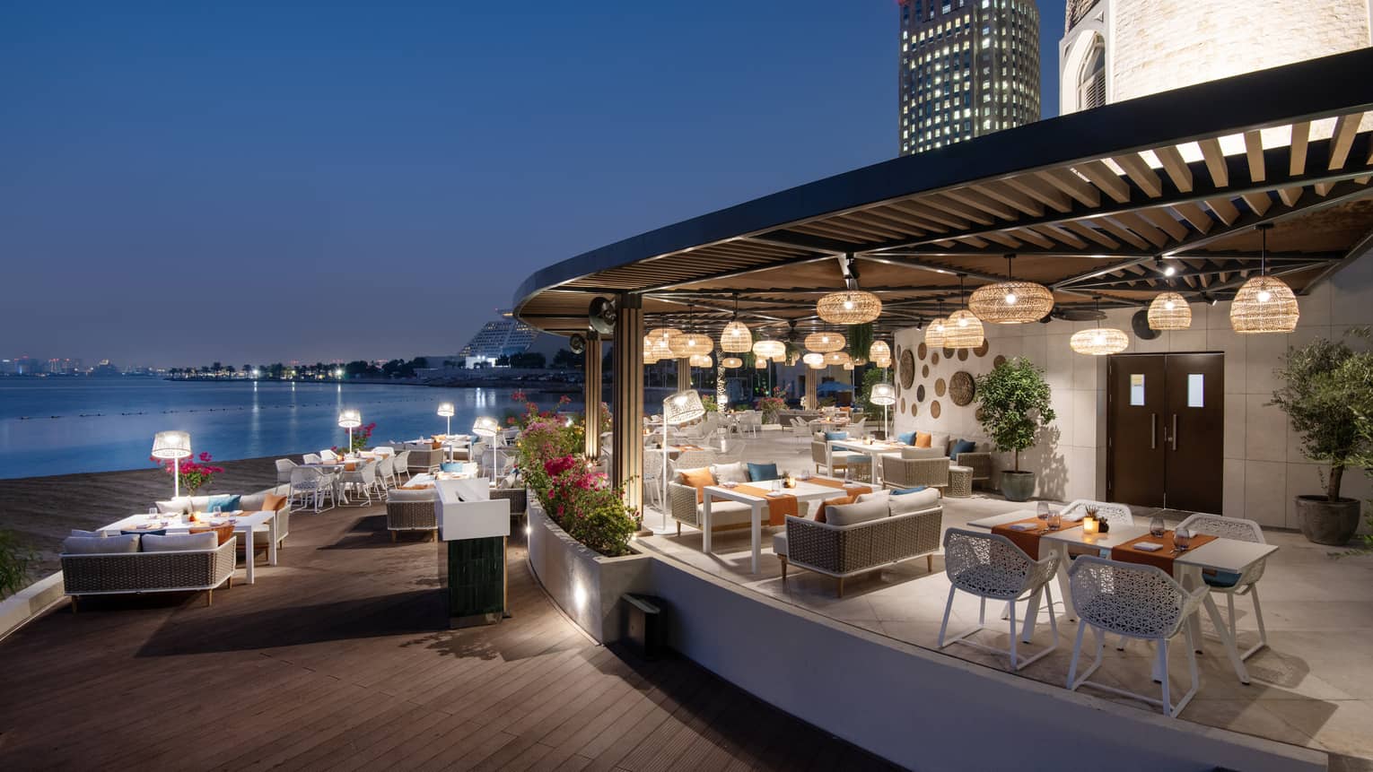 Makani Beach Club terrace overlooking the water at dusk