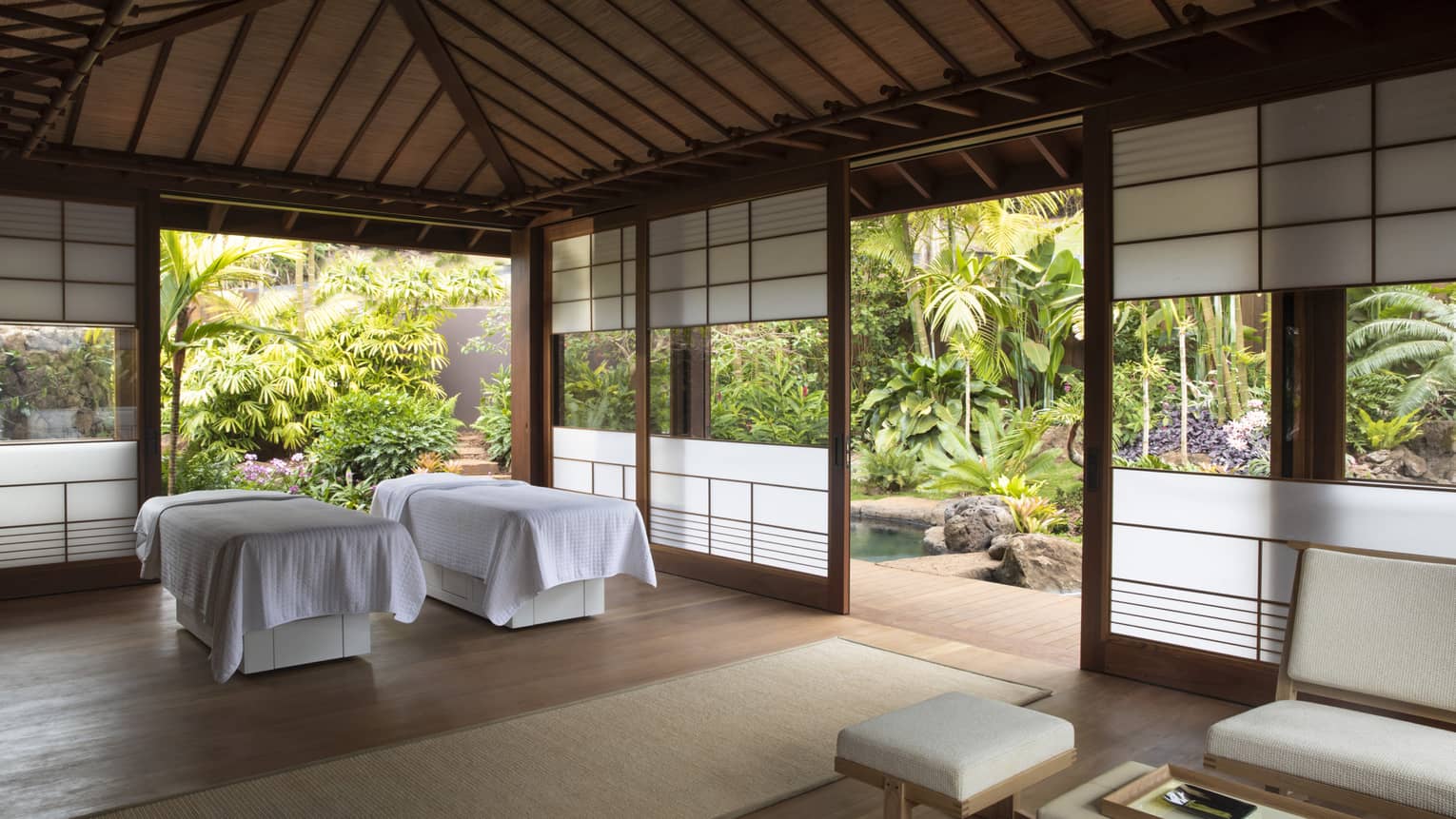 An airy indoor spa surrounded by lush flora