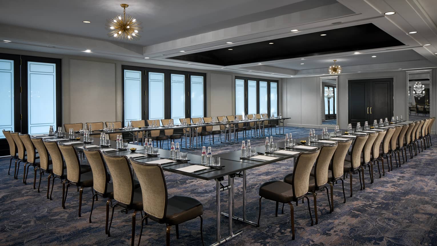 Tables and chairs with place-settings in the Dumbarton Room arranged in a U-shape