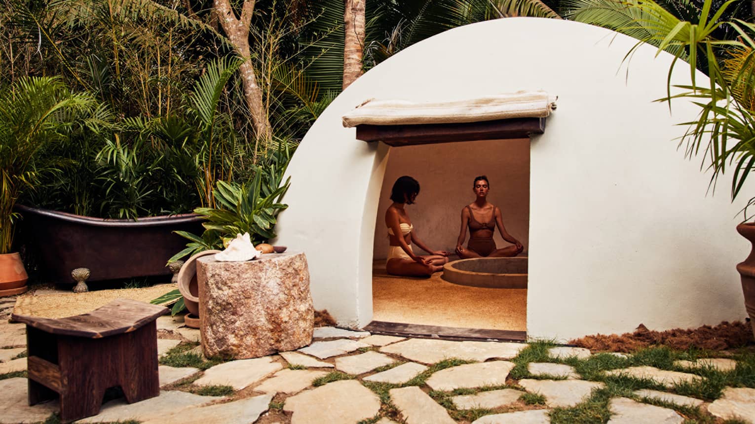 A heated dome shaped room surrounded by trees.