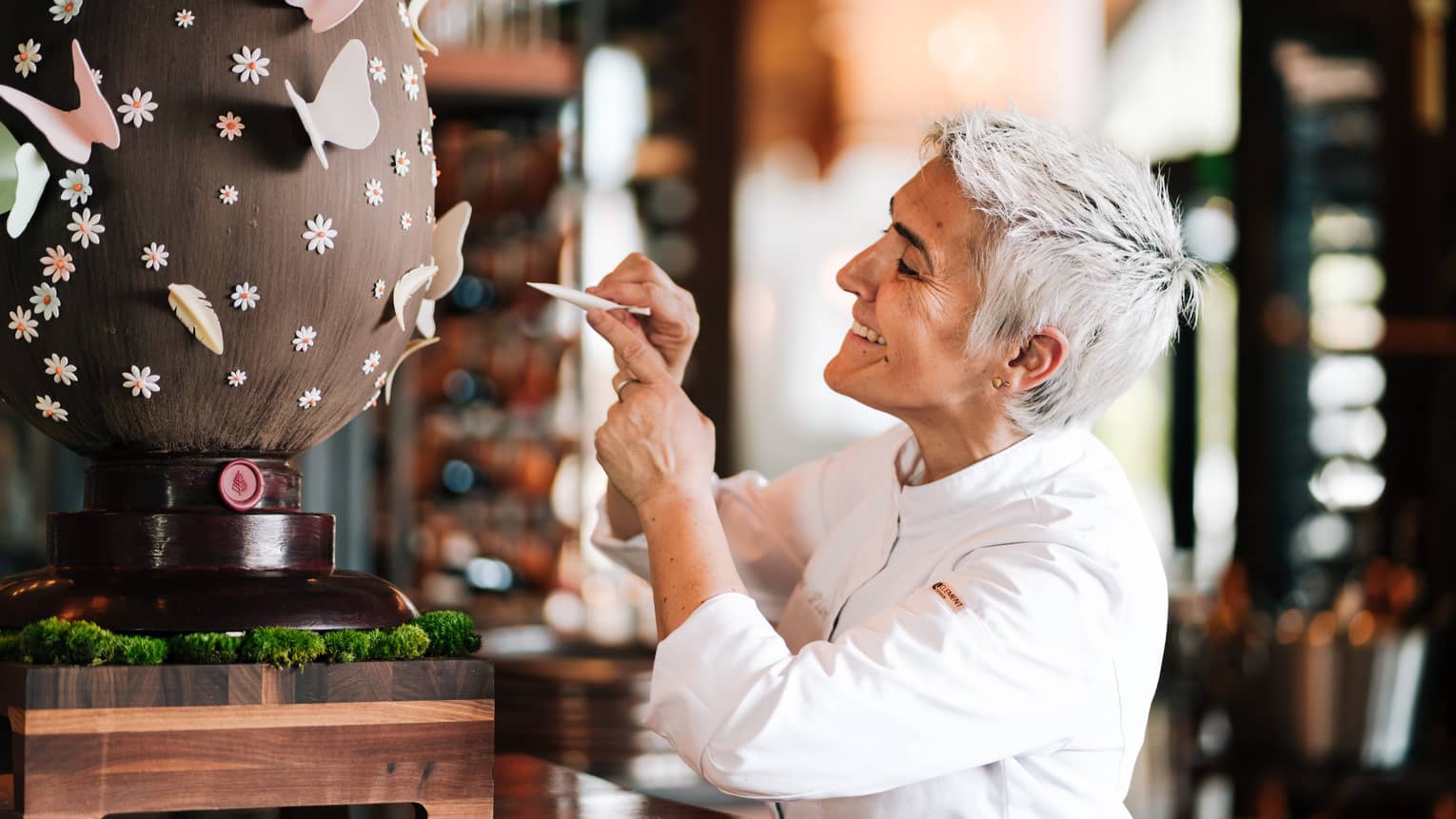 A chef decorates a giant chocolate egg