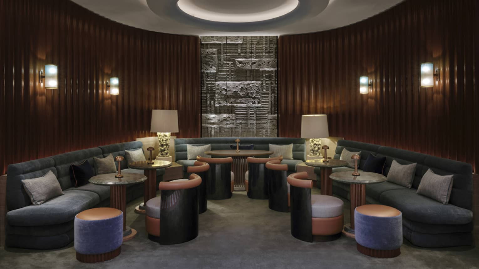 Lounge with large curved sofa, molding to curved wooden walls