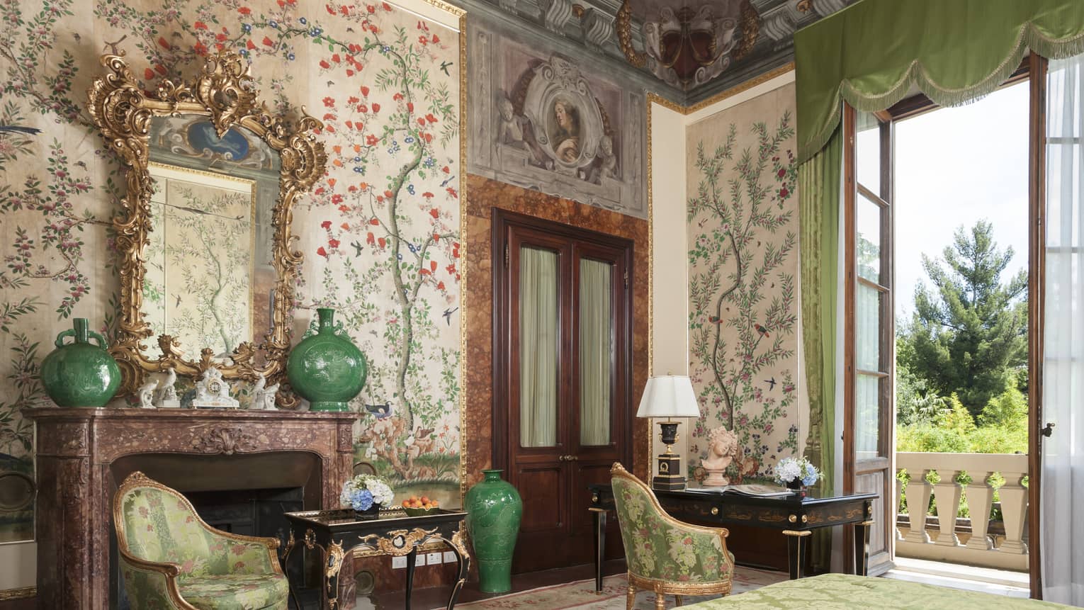Hotel room with elaborate floral wall paper and fresco ceiling