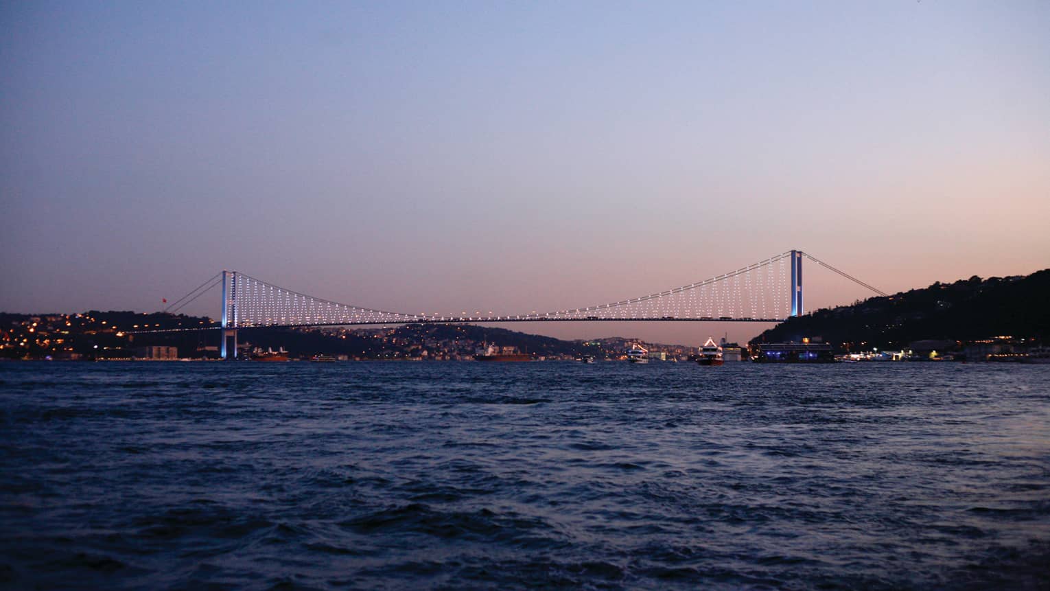 Lights on bridge over the Bosphorus at sunset