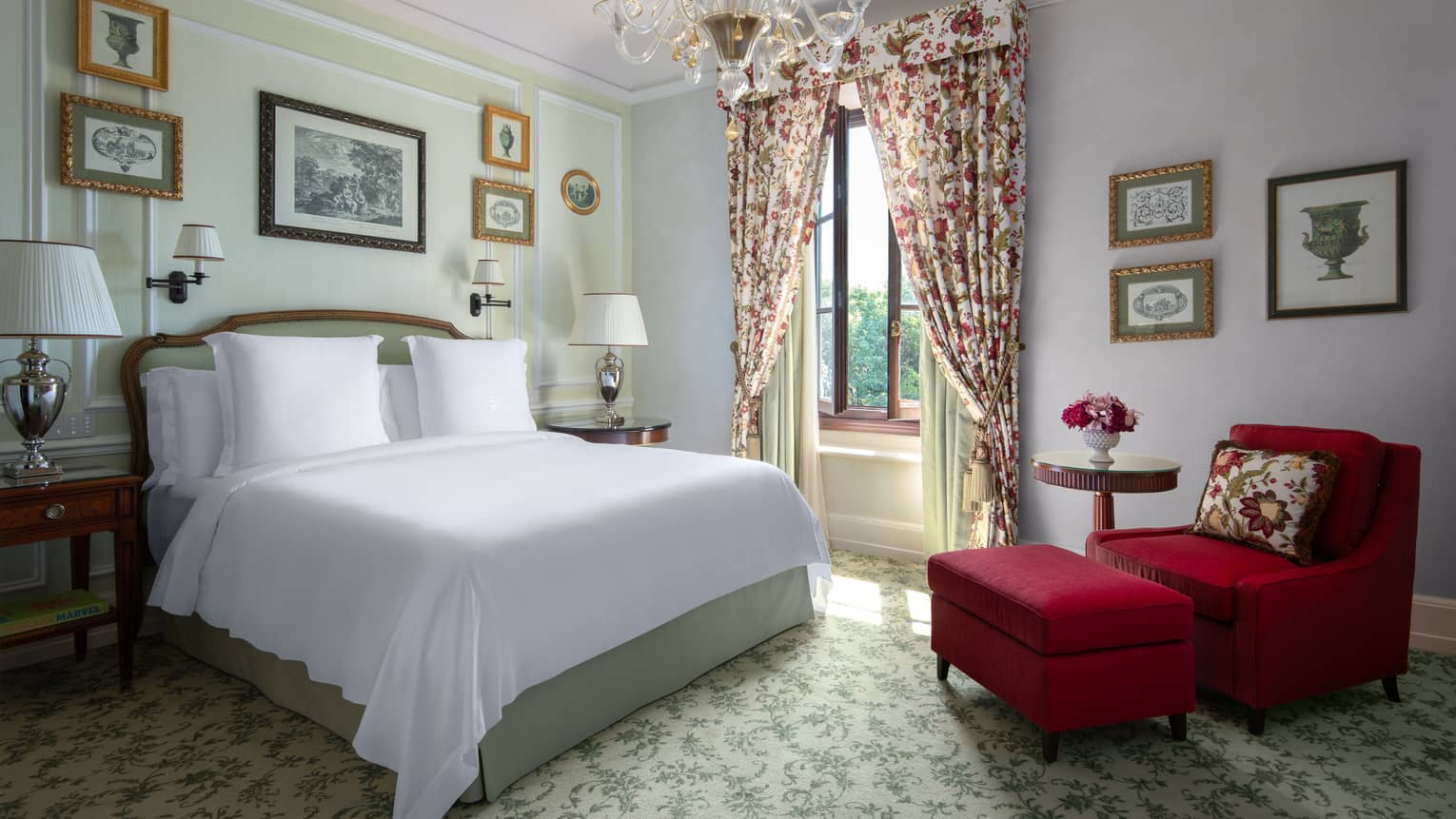 Luxury hotel room with king bed, red arm chair and ottoman, chandelier and elegant window curtains  at Four Seasons Hotel Florence