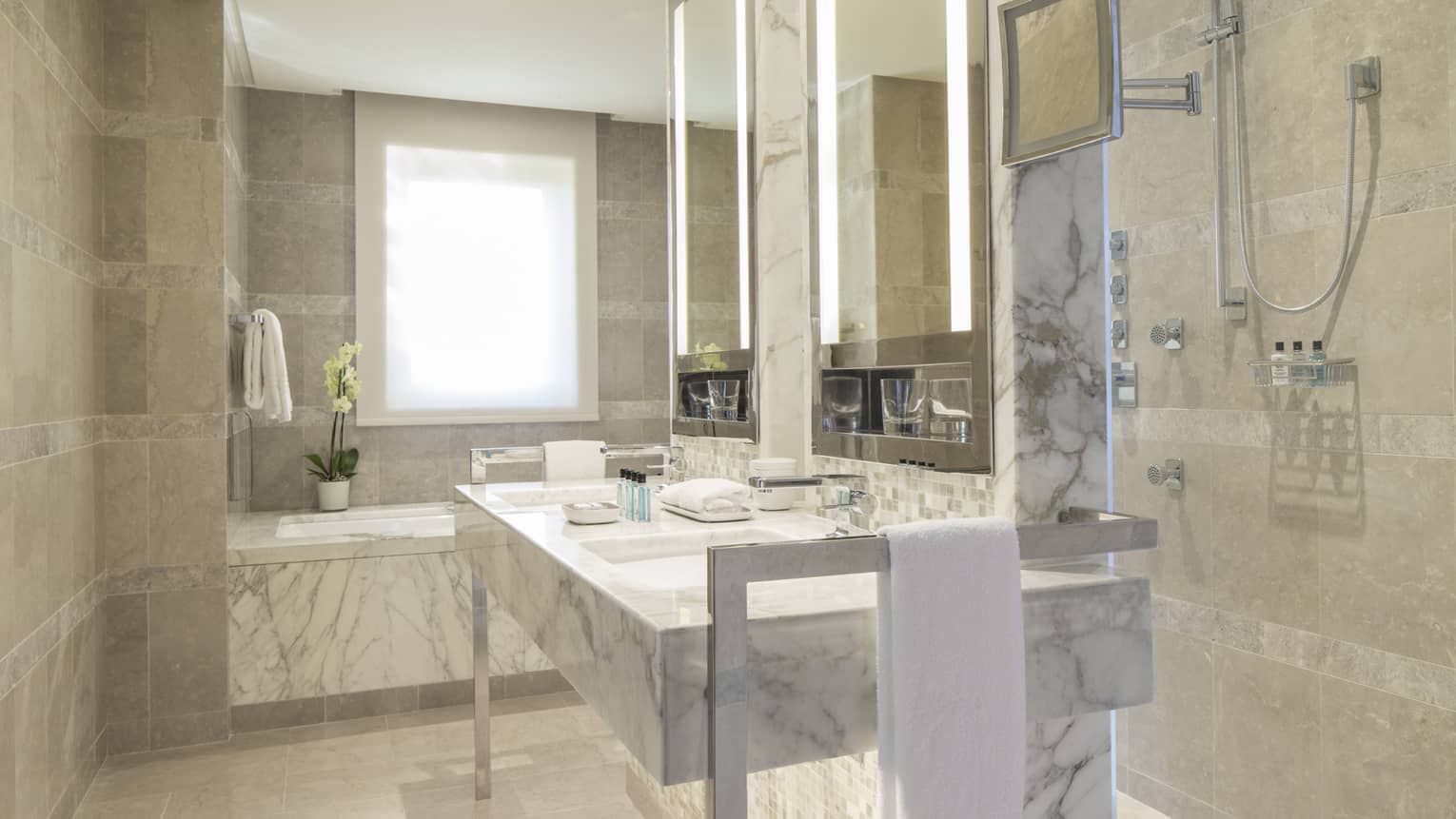 Executive Suite full white and grey marble bathroom, vanity with double sink, tub