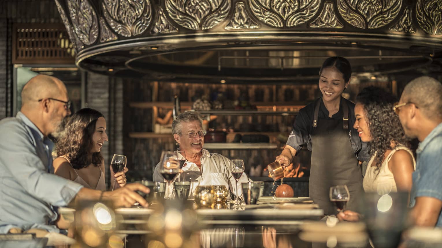 Family gathered around a restaurant table, celebrating a holiday dinner together