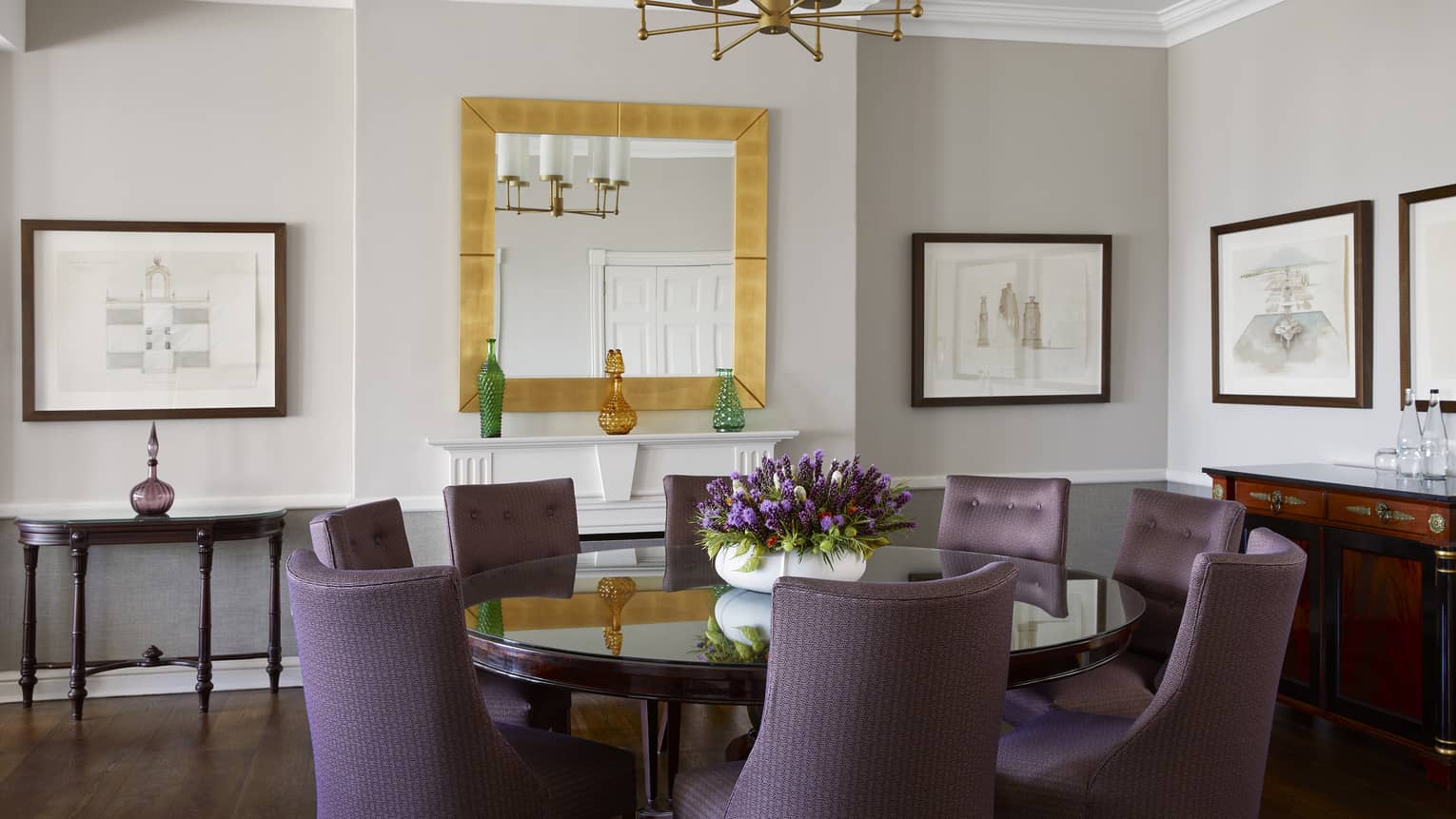 Luxury hotel suite dining room, with round table and eight violet upholstered chairs, at Four Seasons Hotel Johannesburg