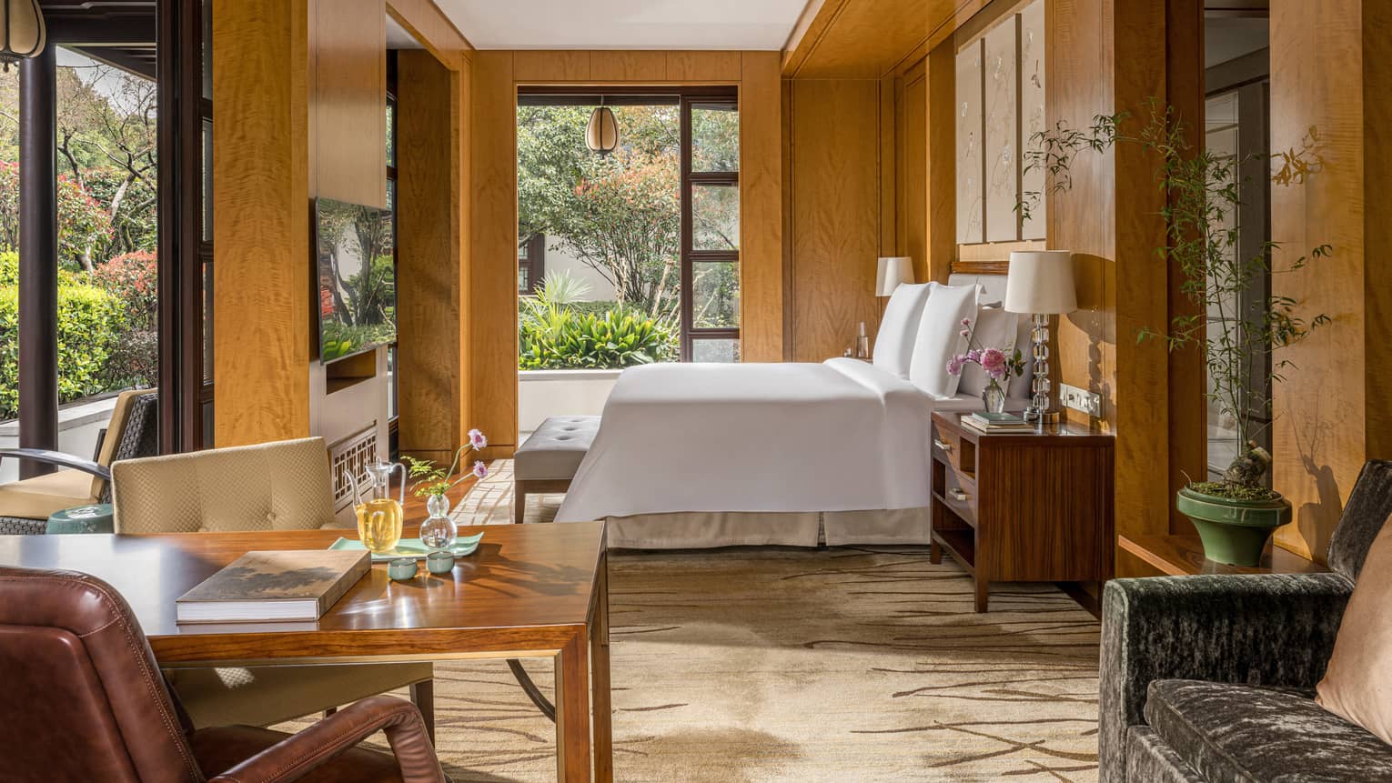 Luxury hotel guest room featuring king bed and garden views