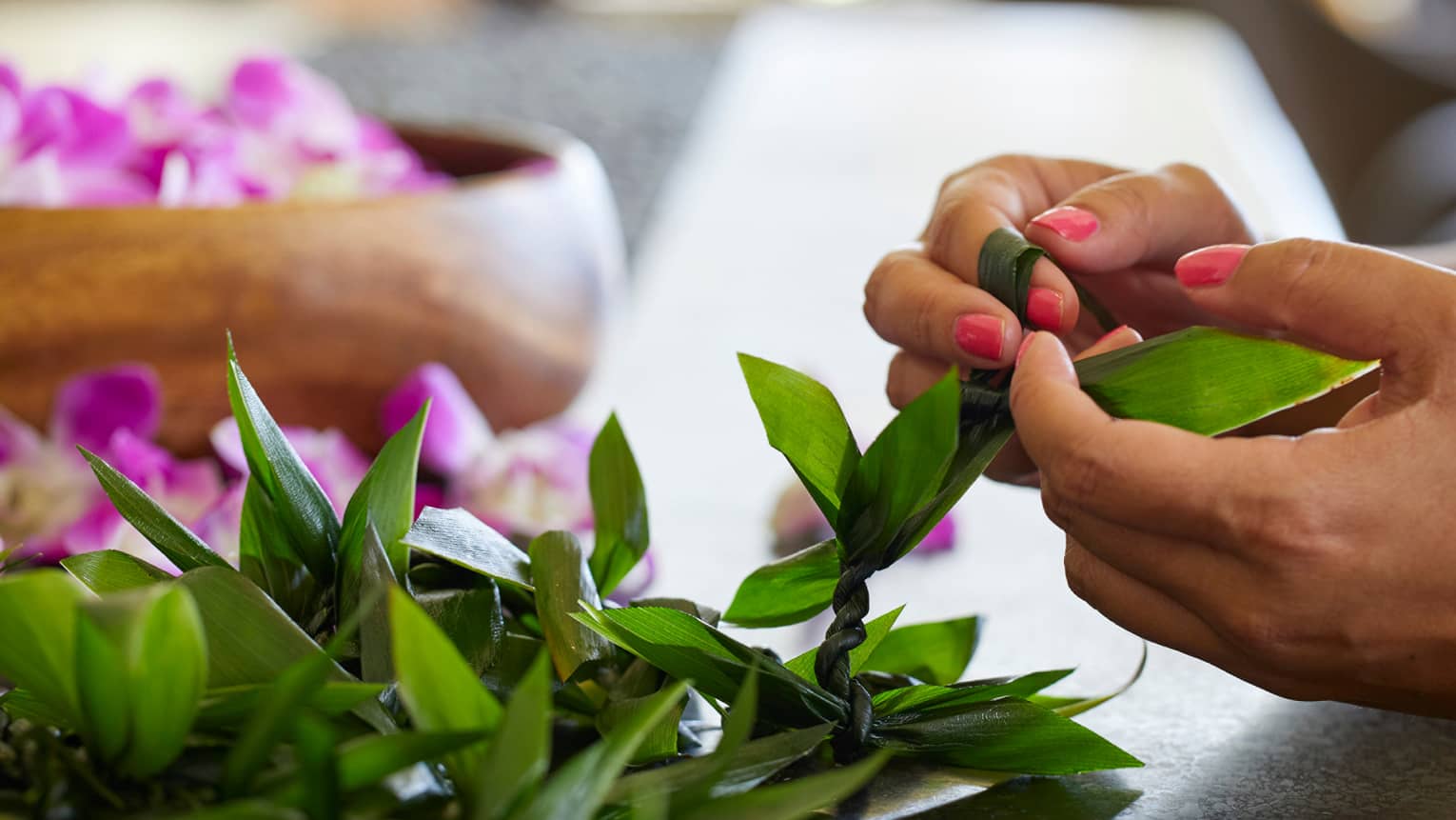Guests weave leis out of fresh materials