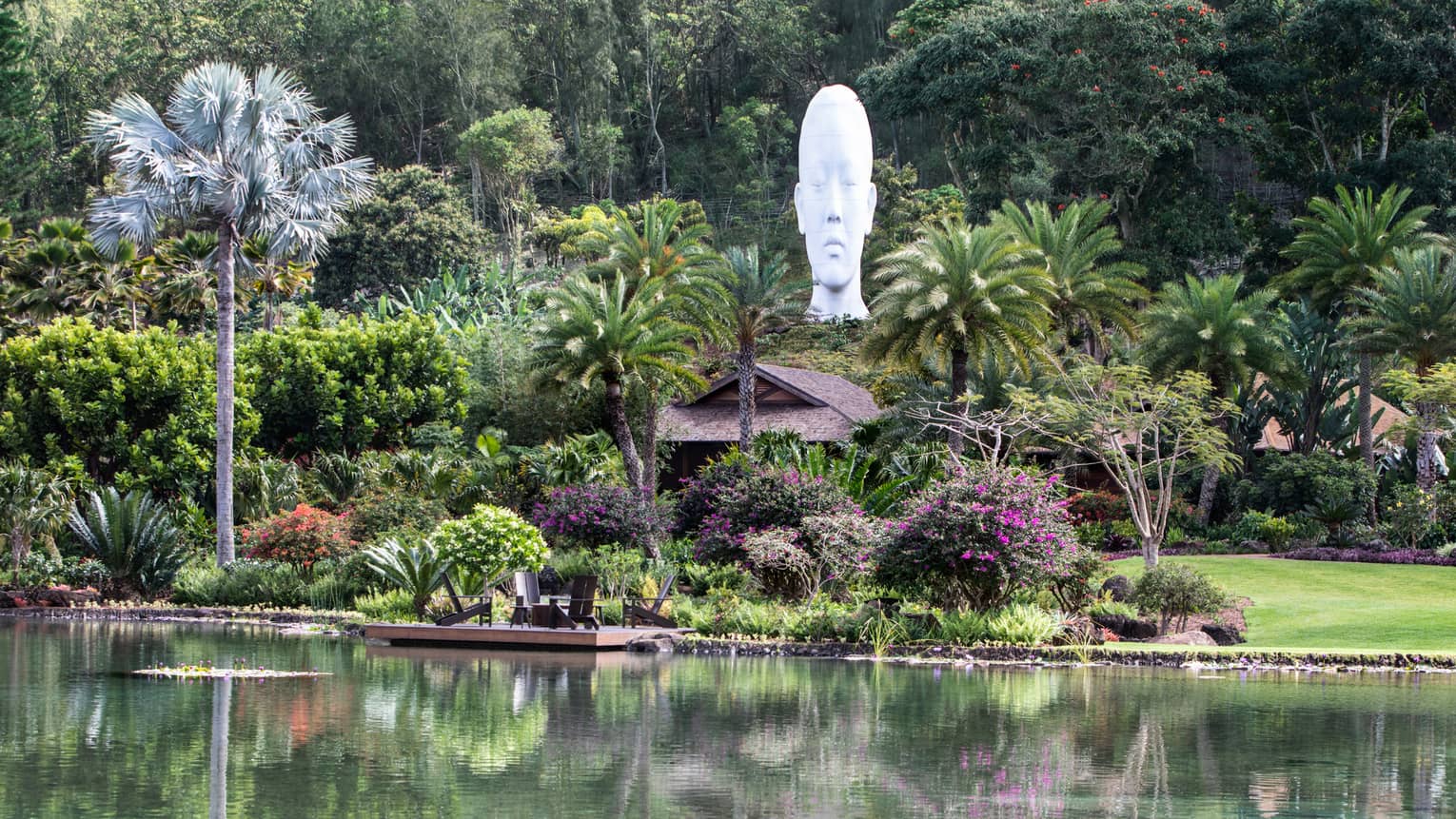 Lush tropical grounds of resort with sculpture head