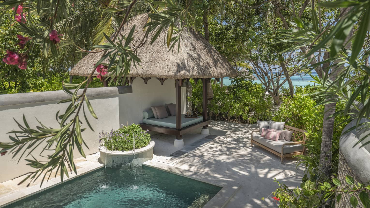 Private pool with thatched-roof cabana