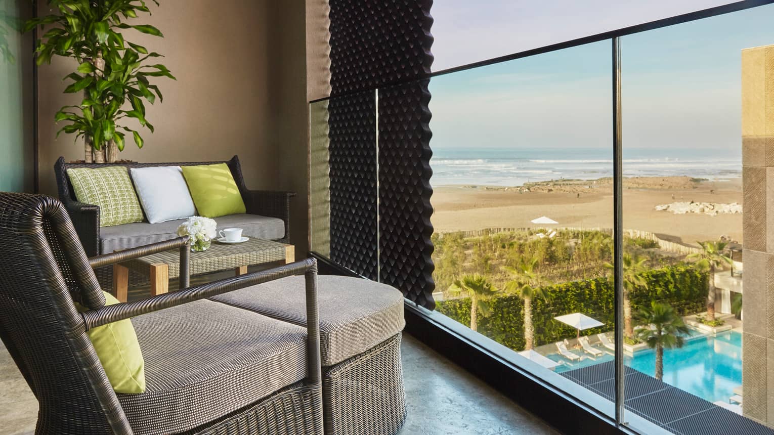 Premier Room balcony large wicker chairs with cushions, lime green accent pillows, beach views