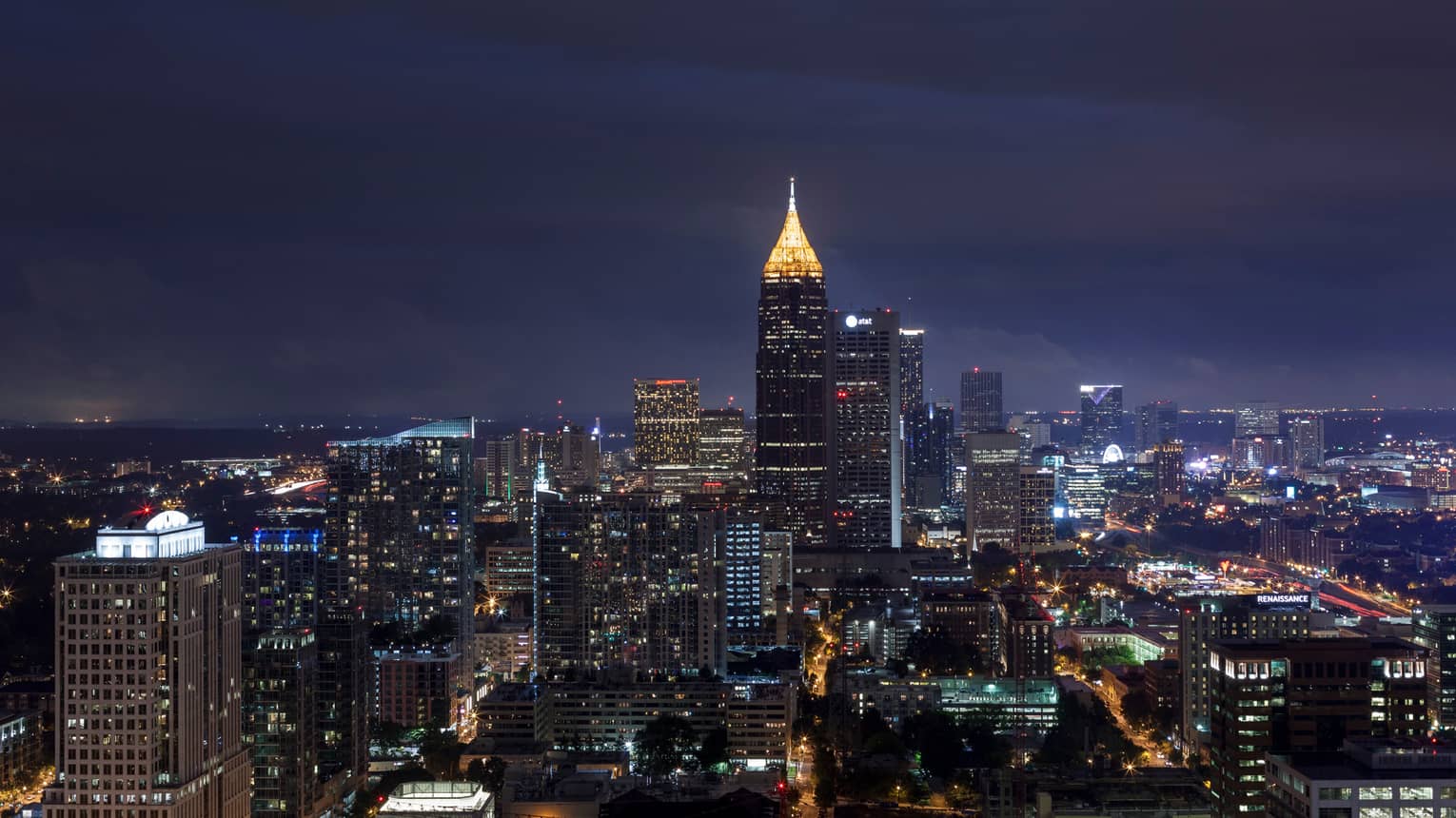 Looking down over Atlanta skyline at night with skyscrapers, Bank of America Plaza tower lit up 