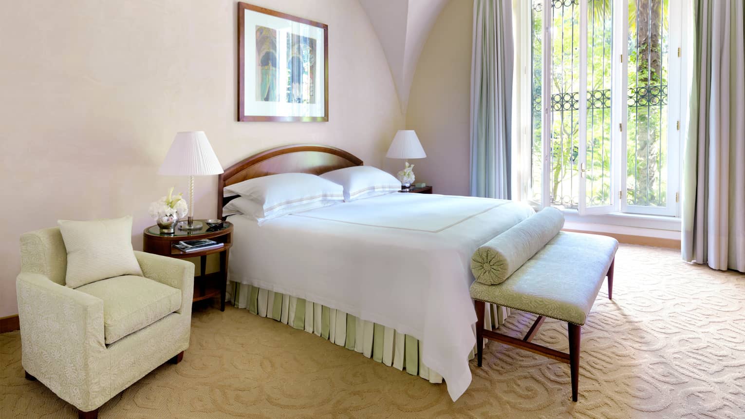 Cloister Suite bed, silk bench at foot, armchair, sunny balcony door