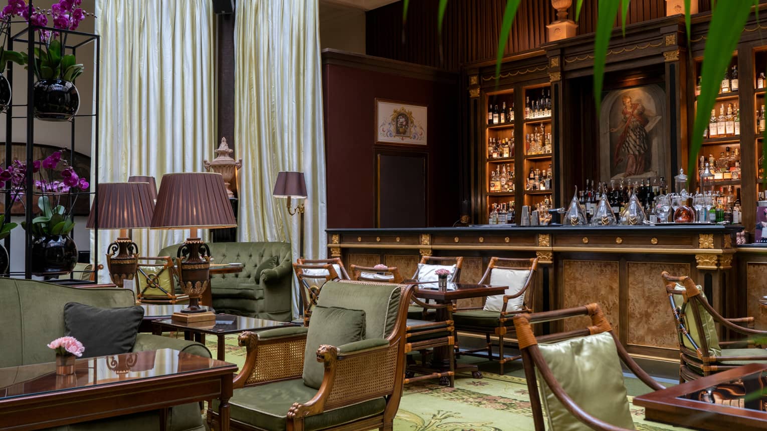 Indoor bar with rich wooden furniture and sage-green accents