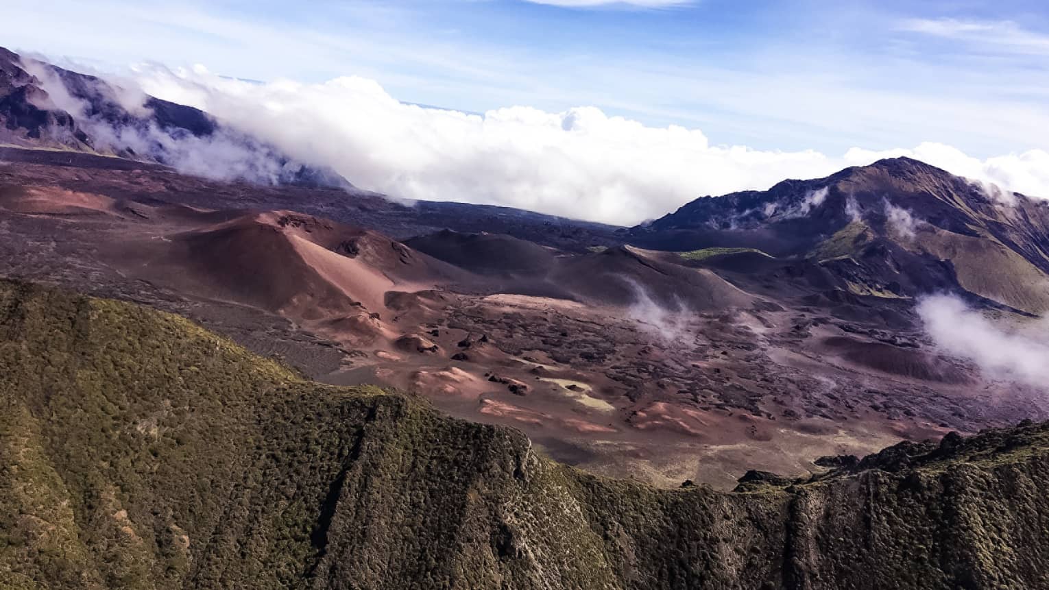 A dormant volcano crater sits above the clouds at Haleakala National Park