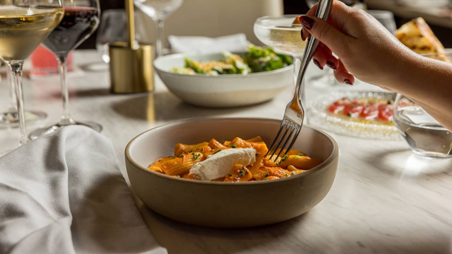 Rigatoni served in a beige stoneware bowl