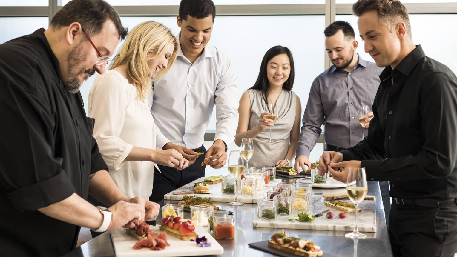 Chef assembles appetizer platters at group cooking class 