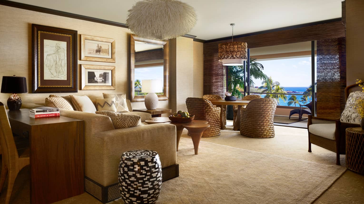 Penthouse Prime Oceanfront Suite wood desk with books against sofa, living room, rattan dining set