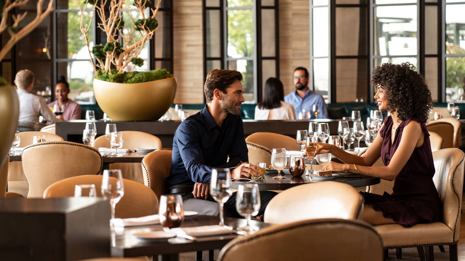 Couple dine at table in modern Cinder House restaurant