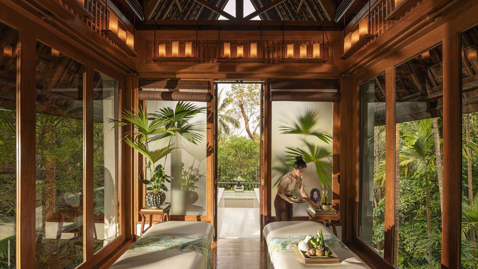 Spa team member prepares couples treatment room