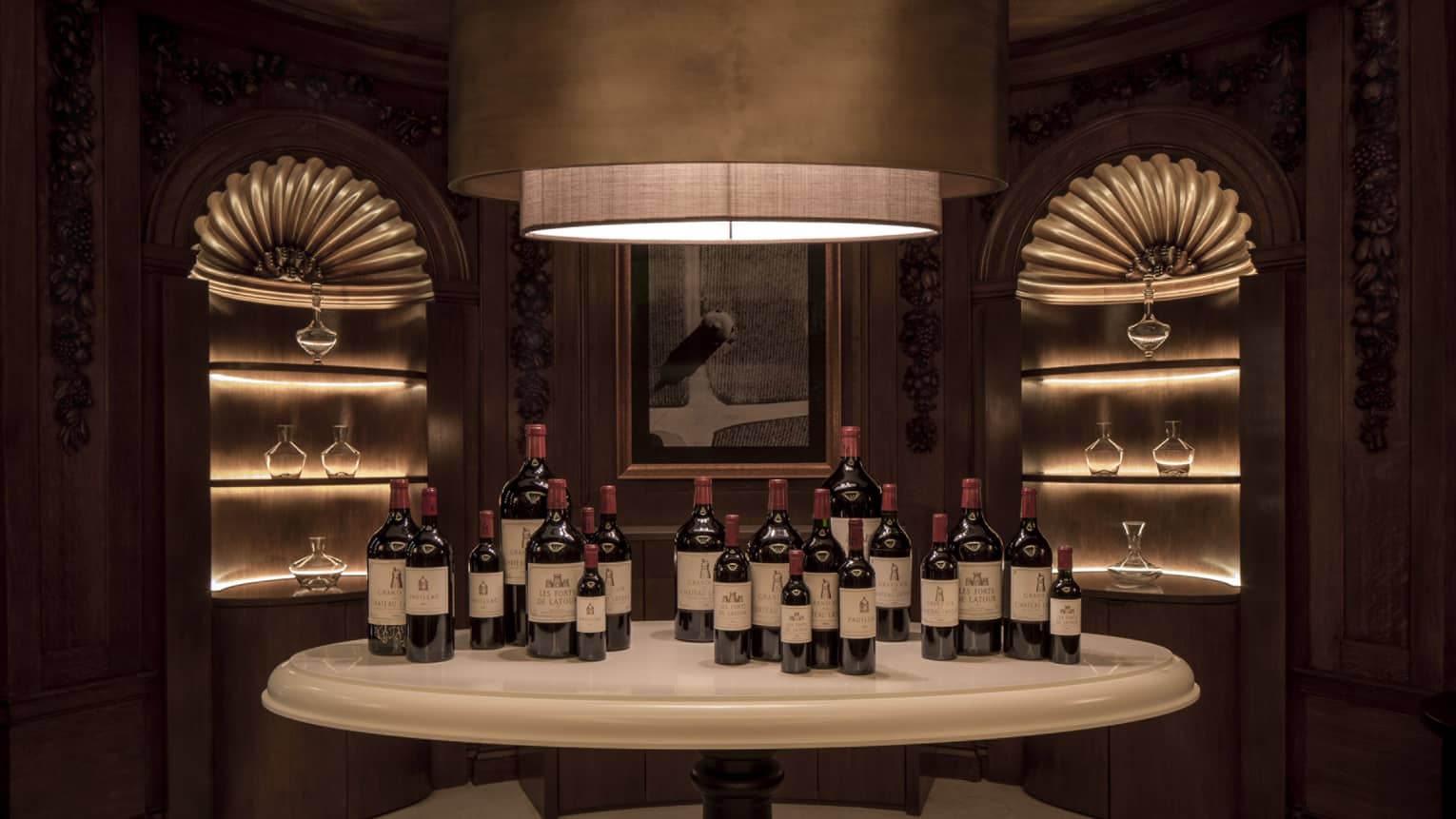 Chateau Latour wine tasting room, wine bottles on table under large modern light