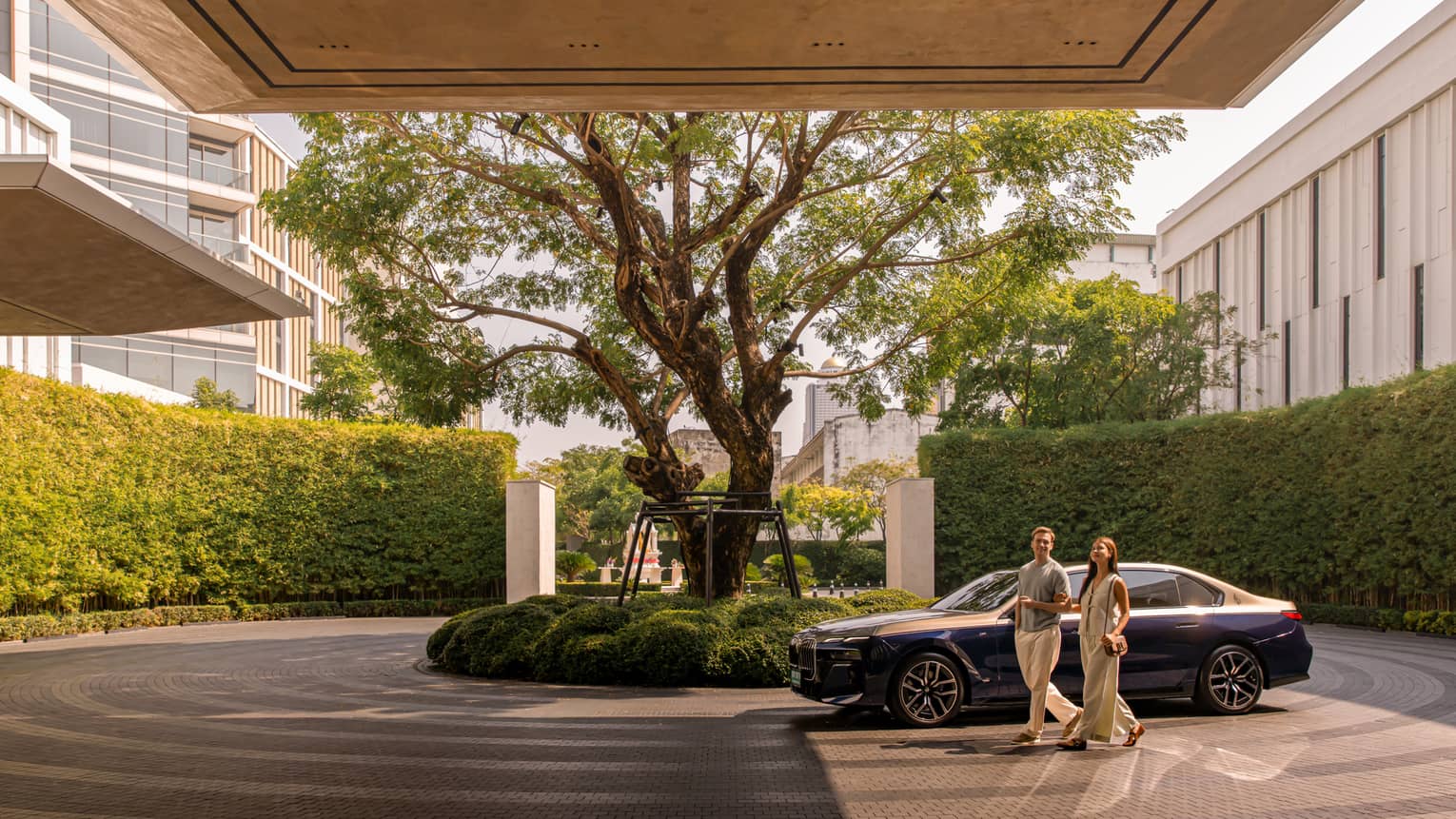 A couple arrives by luxury car to a resort