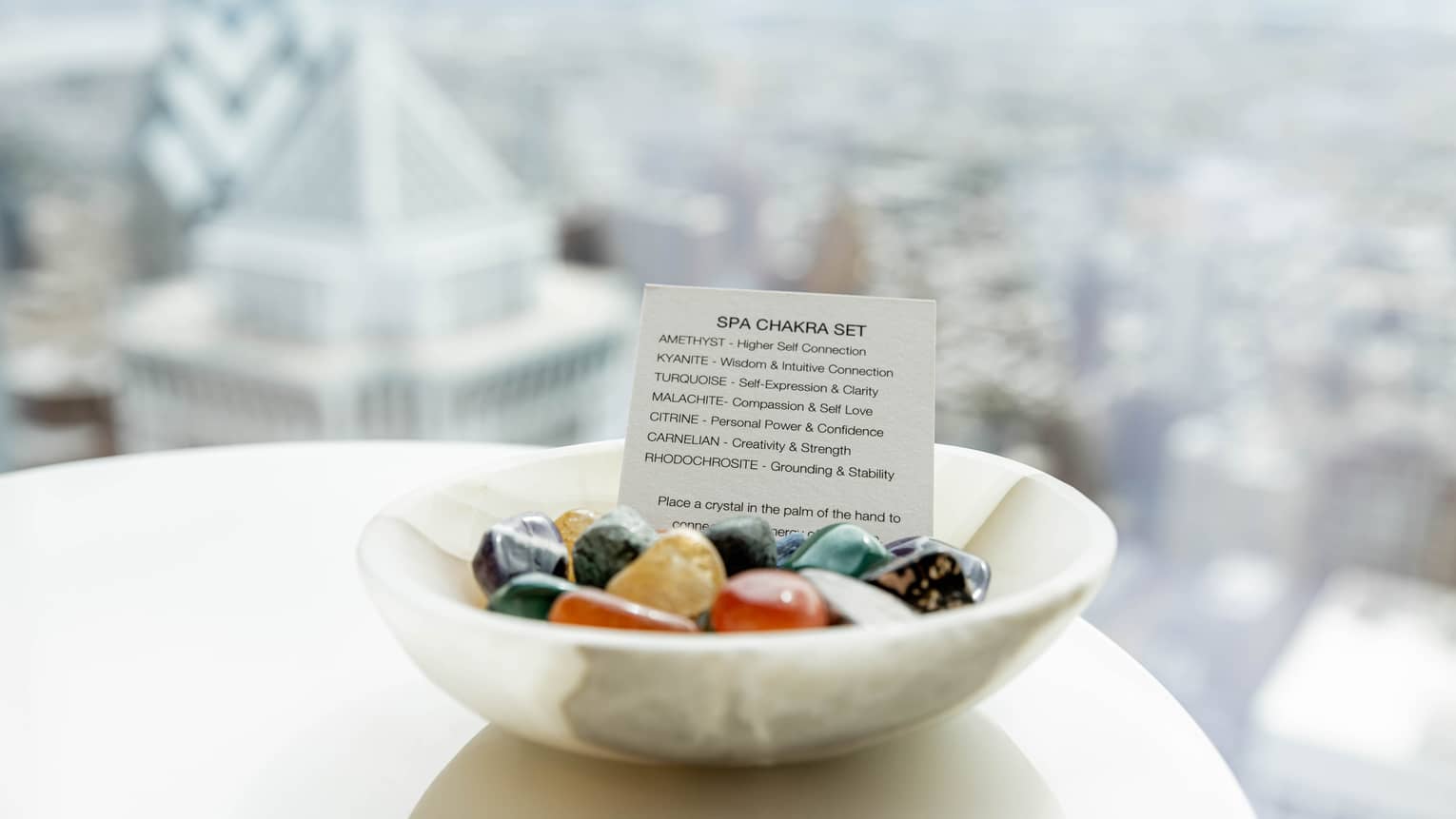 A white bowl of stones and crystals.