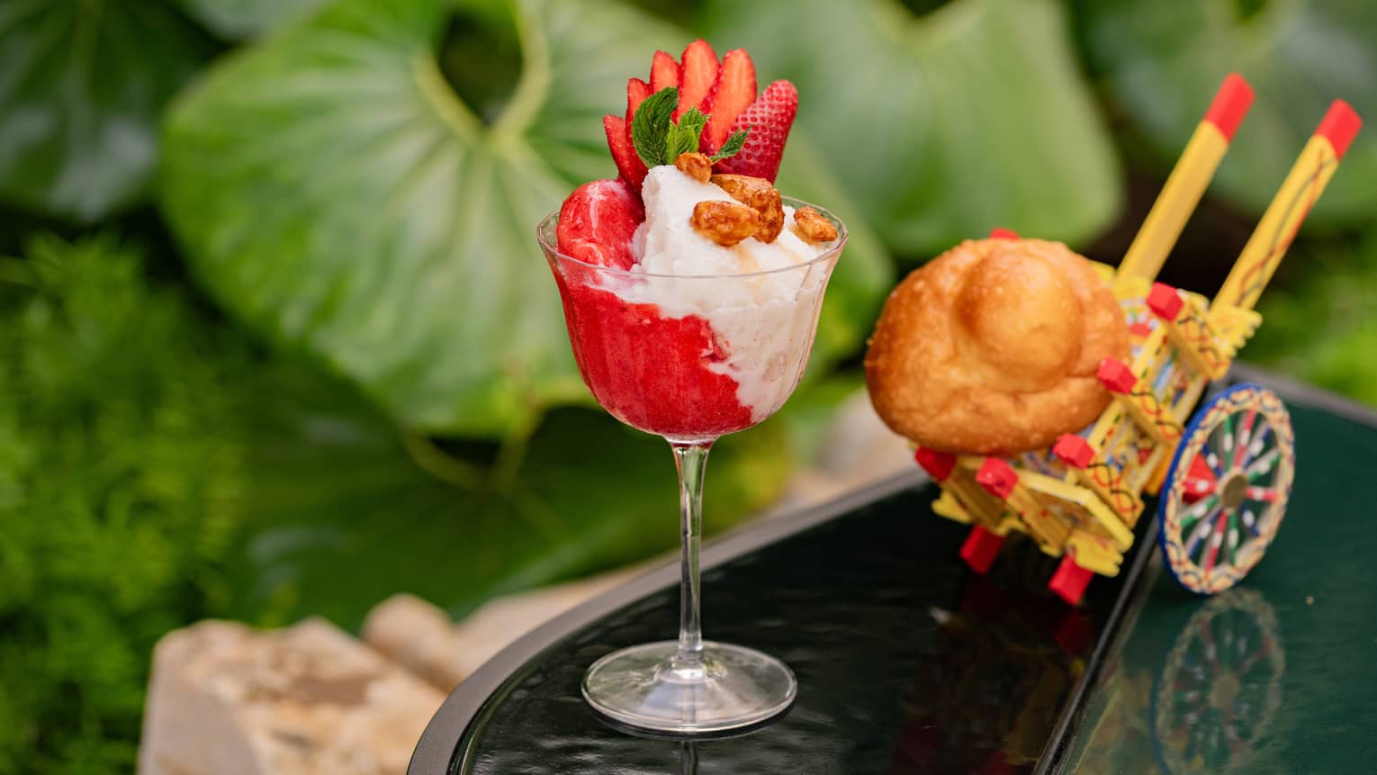 Red-and-white granita topped with sliced strawberry in fluted glass