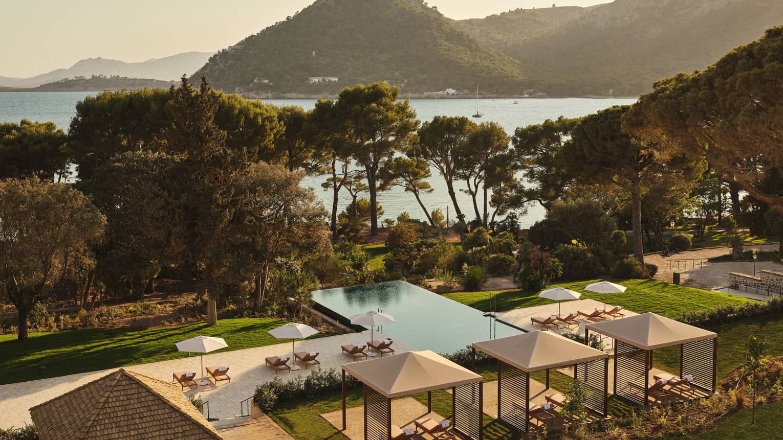 View of pool and ocean/mountain in background
