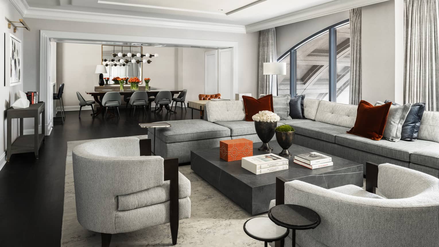 Presidential Suite large seating area with modern grey furniture, dining table