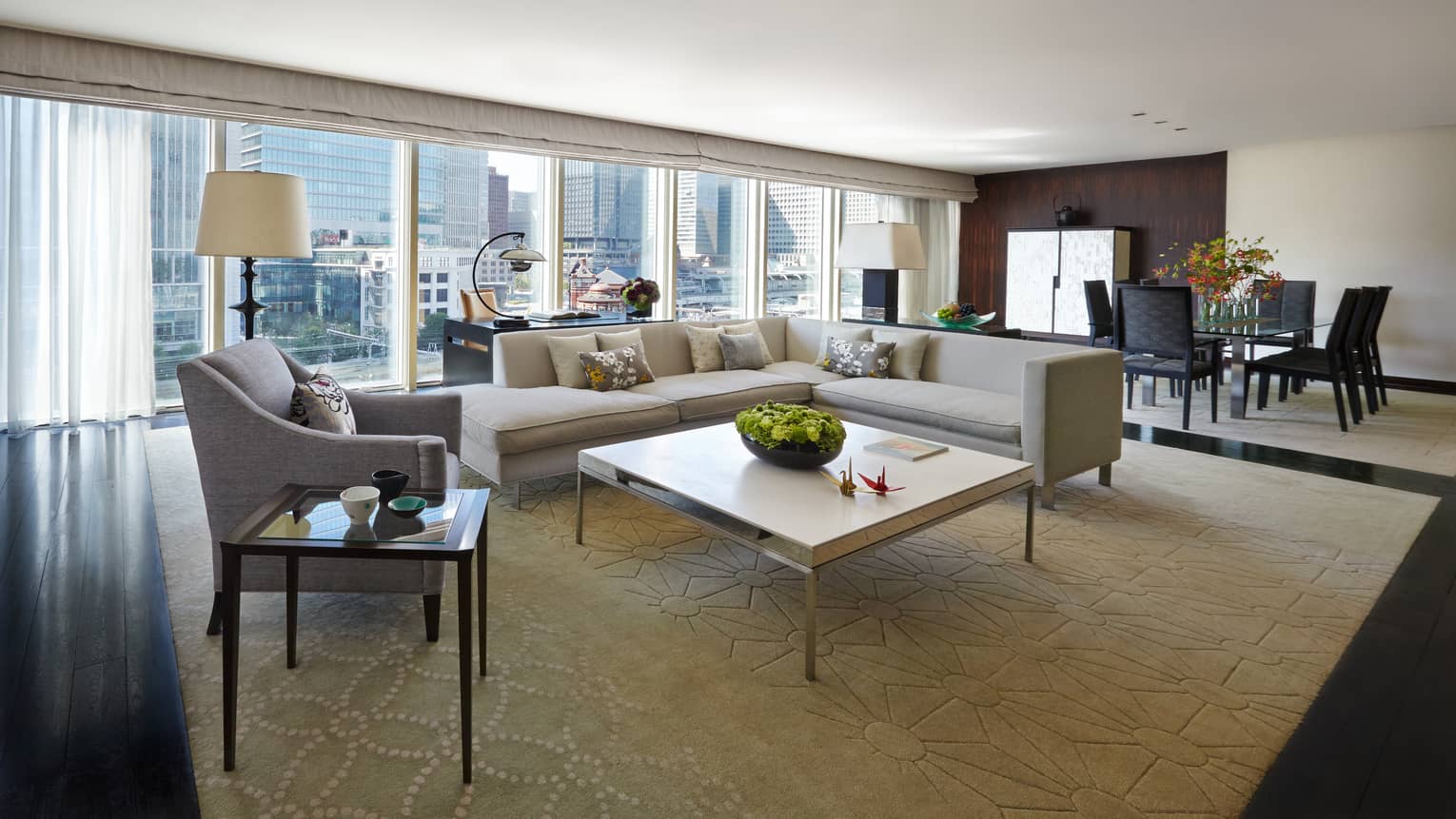 Chairman's Suite modern L-shaped grey sofa, armchair coffee table, wall of windows