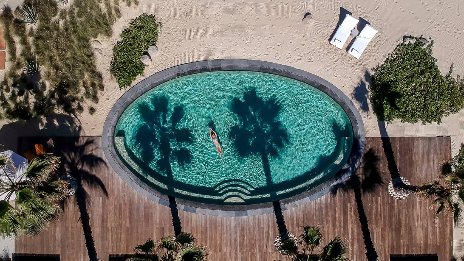 Aerial view of oval pool next to the beach