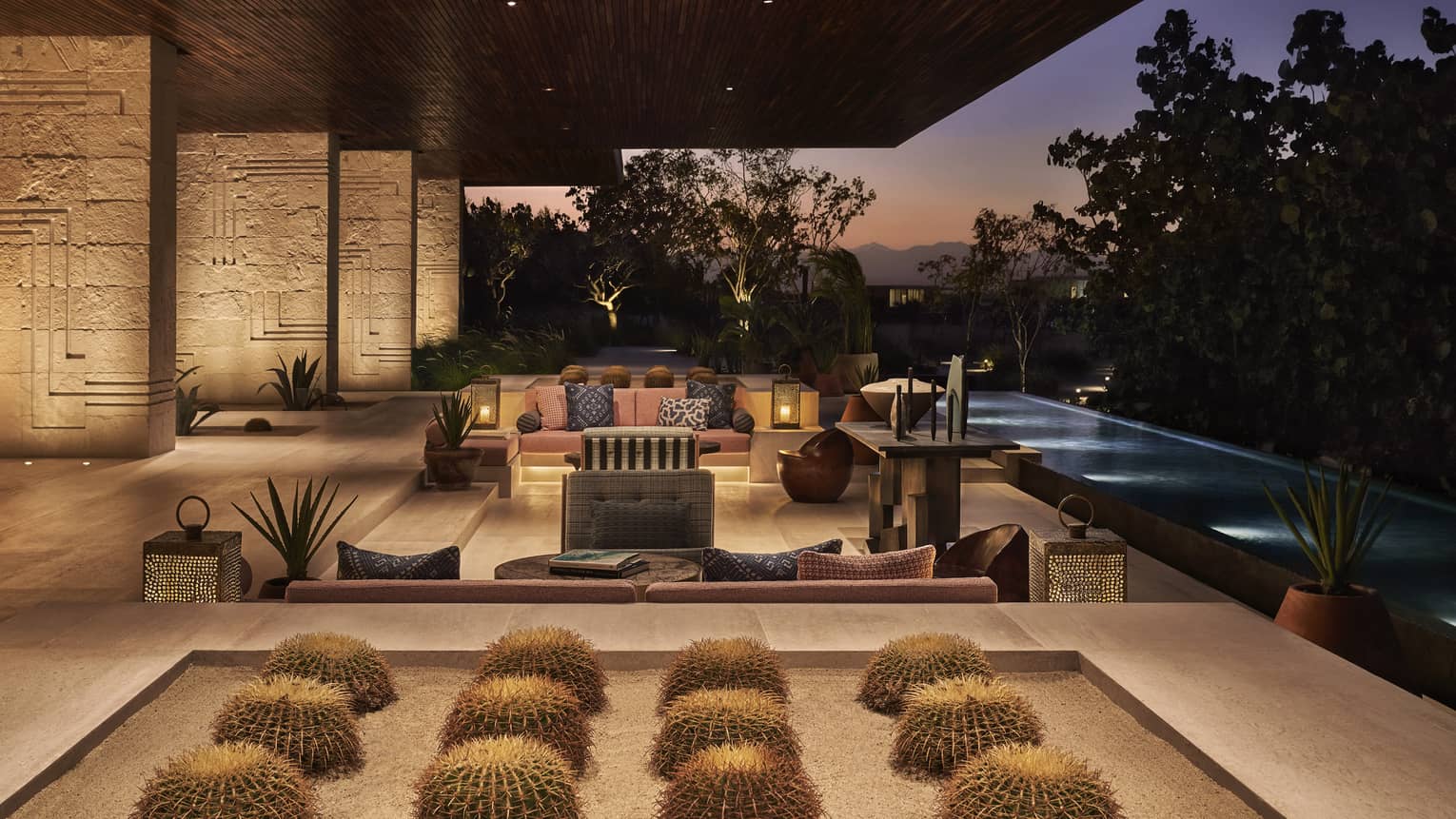 Open air lobby with cactus display, modern patio sofas at dusk