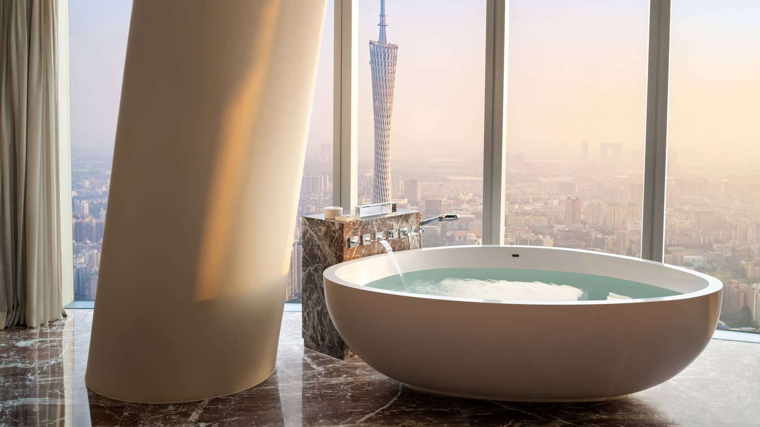 Deluxe Twin Canton Tower View Suite soaking tub with floor-to-ceiling windows