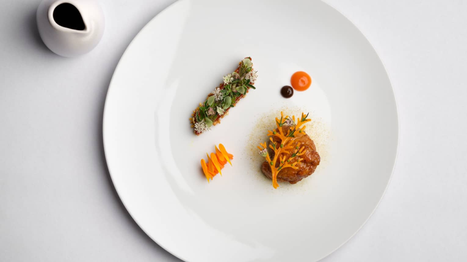 Veal and sweetbread on a white plate.