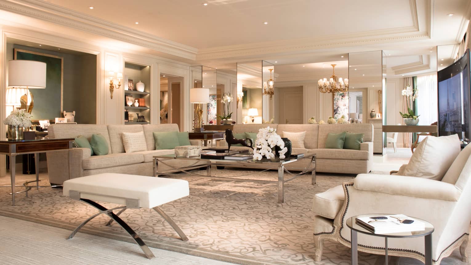 Royal Suite large living room, white sofas, armchairs, lamps, mirror walls