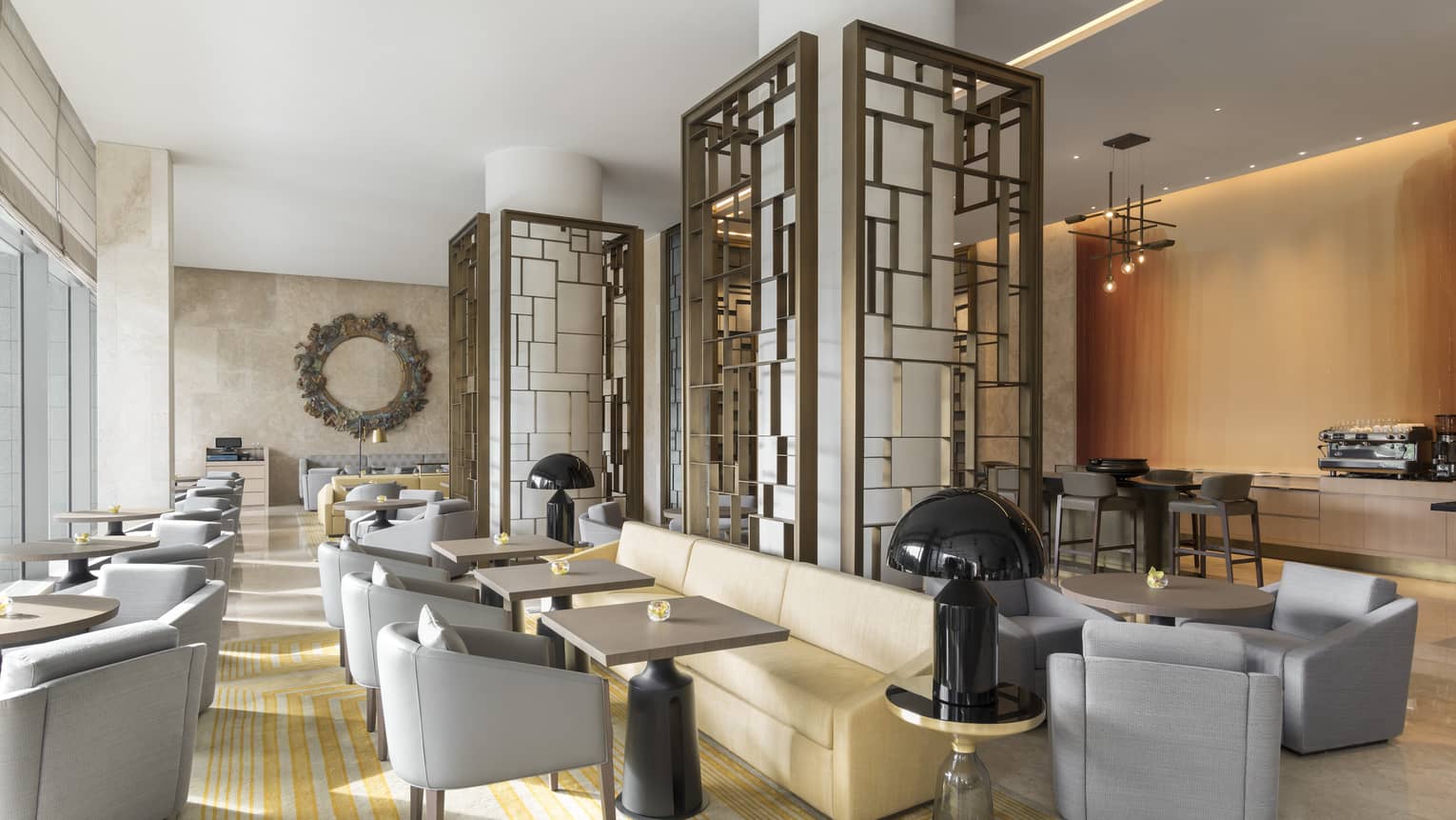 Sculptural lights and geometric artwork decorate a well-lit dining room 