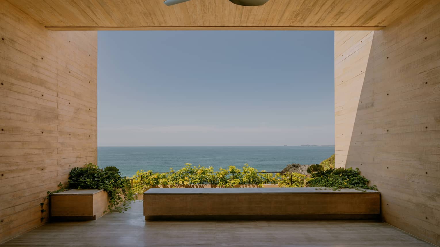 Covered modern terrace looking out to the ocean