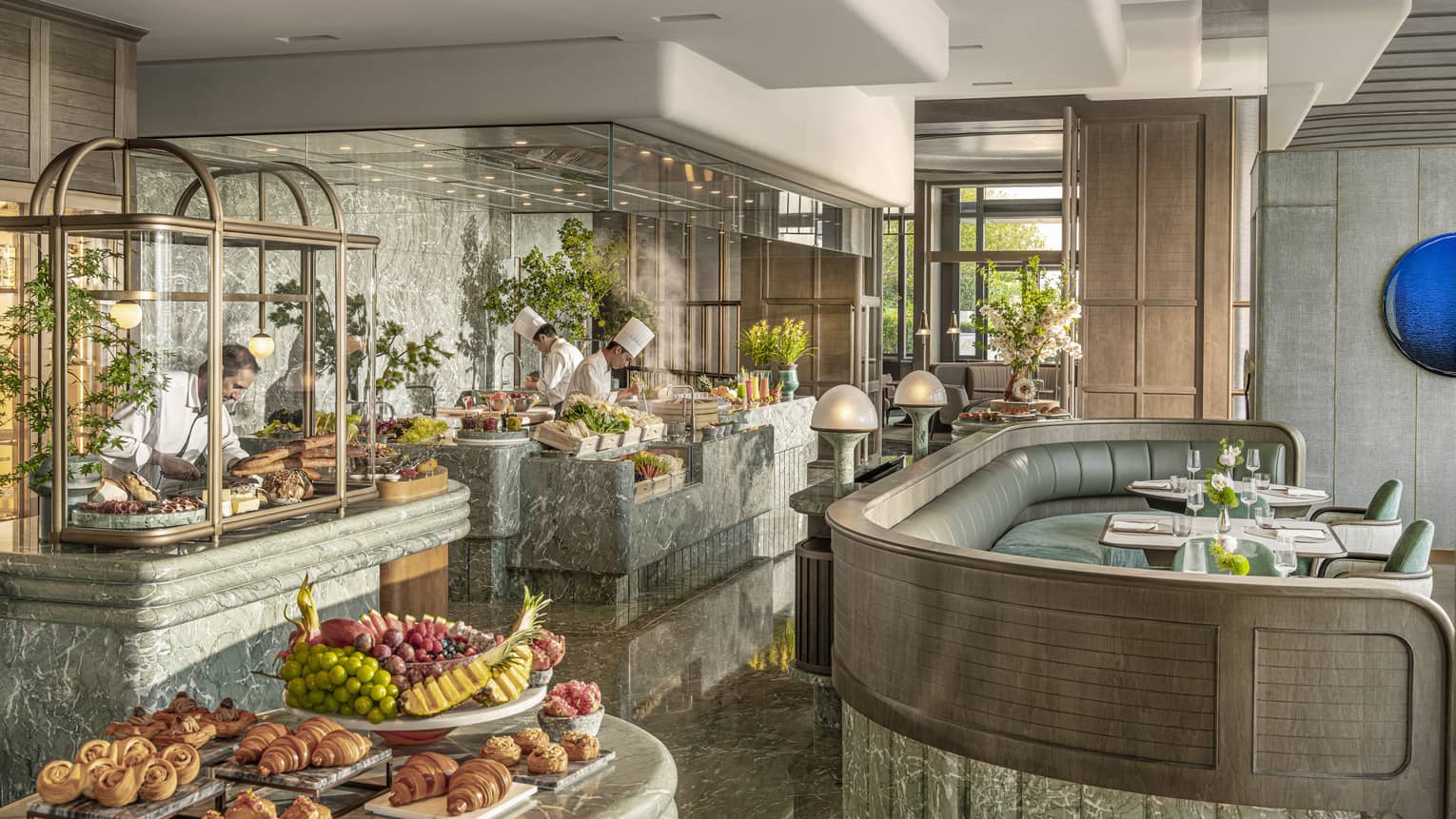 Chefs work at live-cooking stations at all-day restaurant Charm at Four Seasons Hotel Hangzhou at Hangzhou Centre