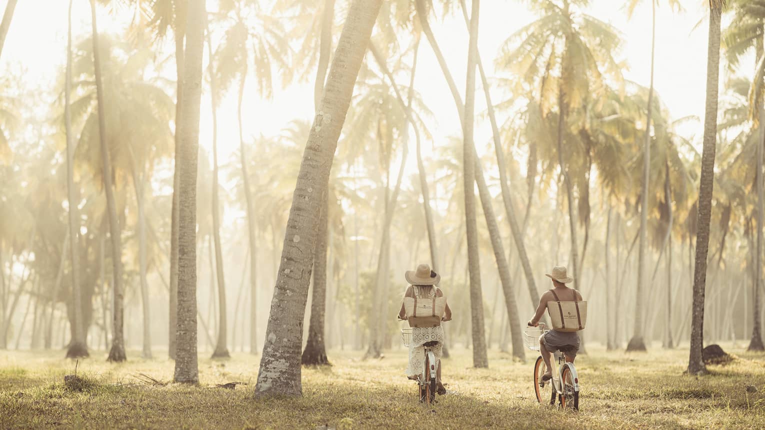 Two people on bicycles explore nature trails on a private island in the Western Indian Ocean