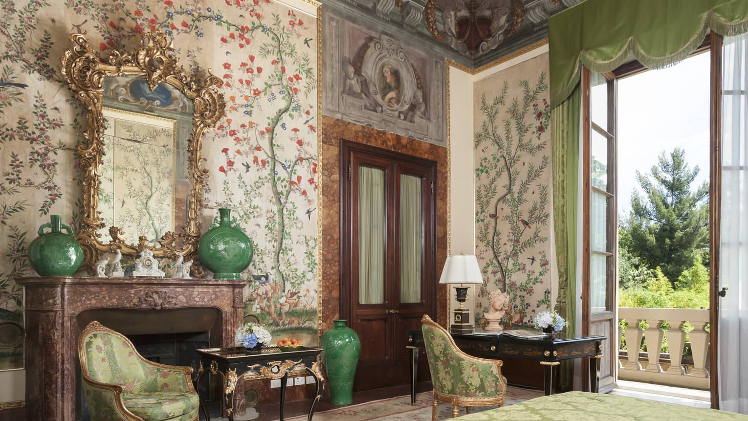 Hotel room with elaborate floral wall paper and fresco ceiling