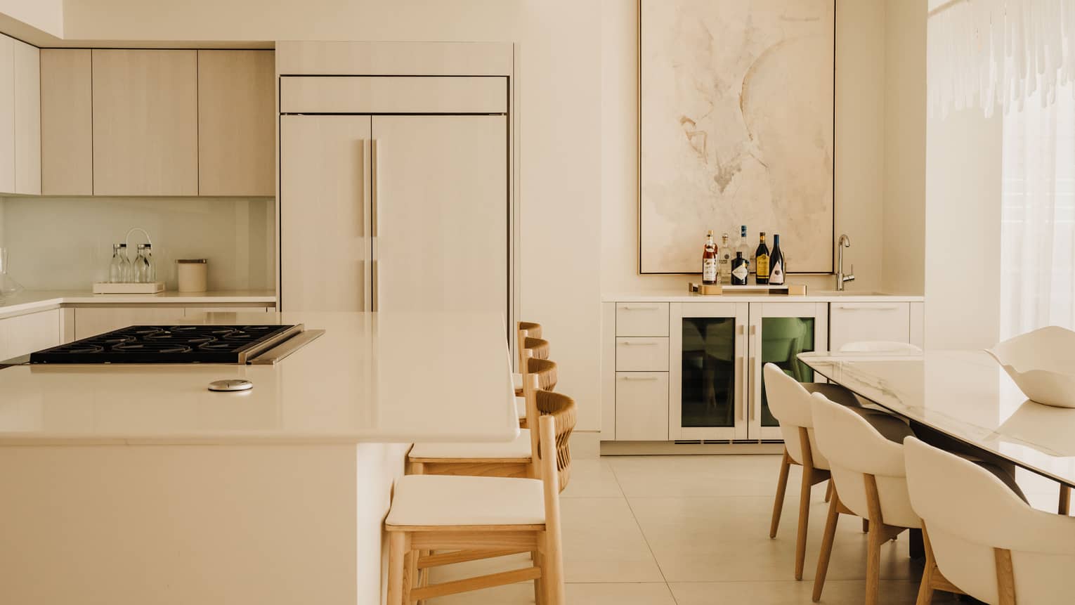 Luxury modern kitchen with counter seating at the island, and a dining table with eight chairs