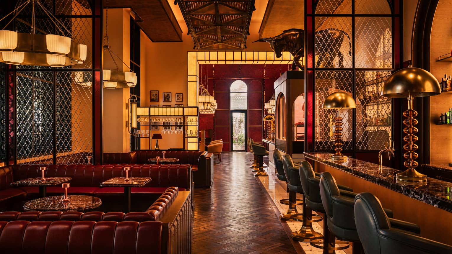 Restaurant dining rool with leather booths and dark wood decor