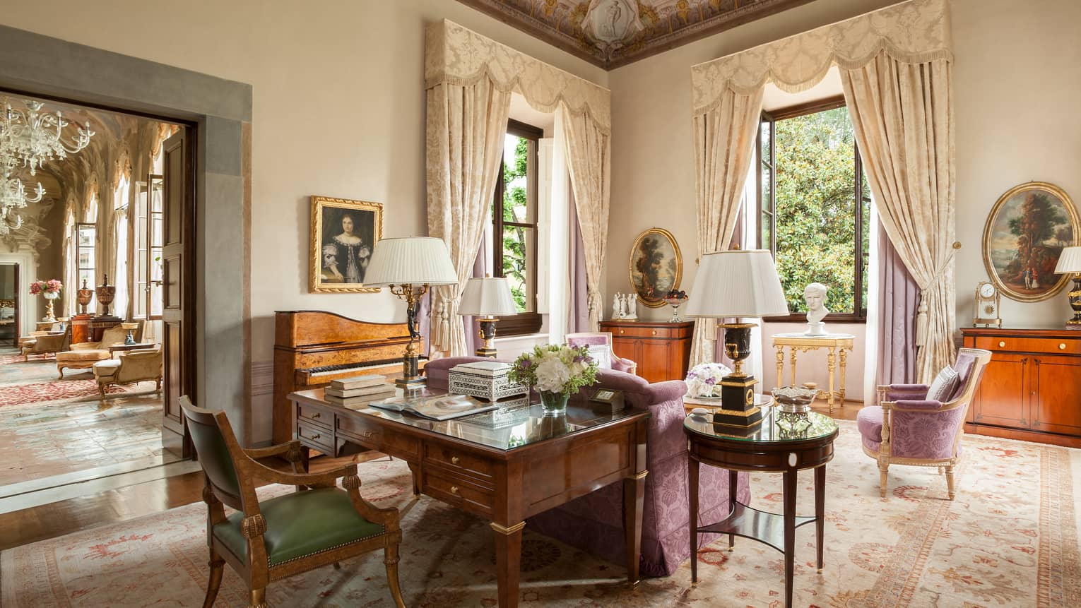 Royal Suite large wood work desk, pink silk sofa and chairs, tall windows under vaulted ceilings