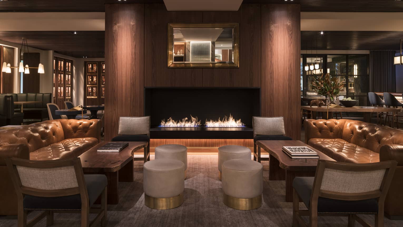 A seating area with sofas near a fire.