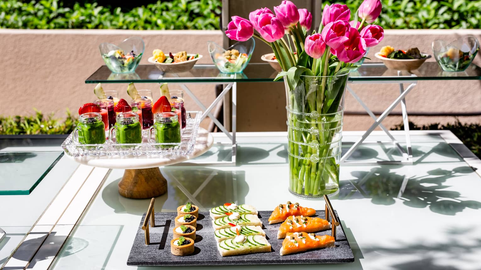 A tray of small foods near flowers.